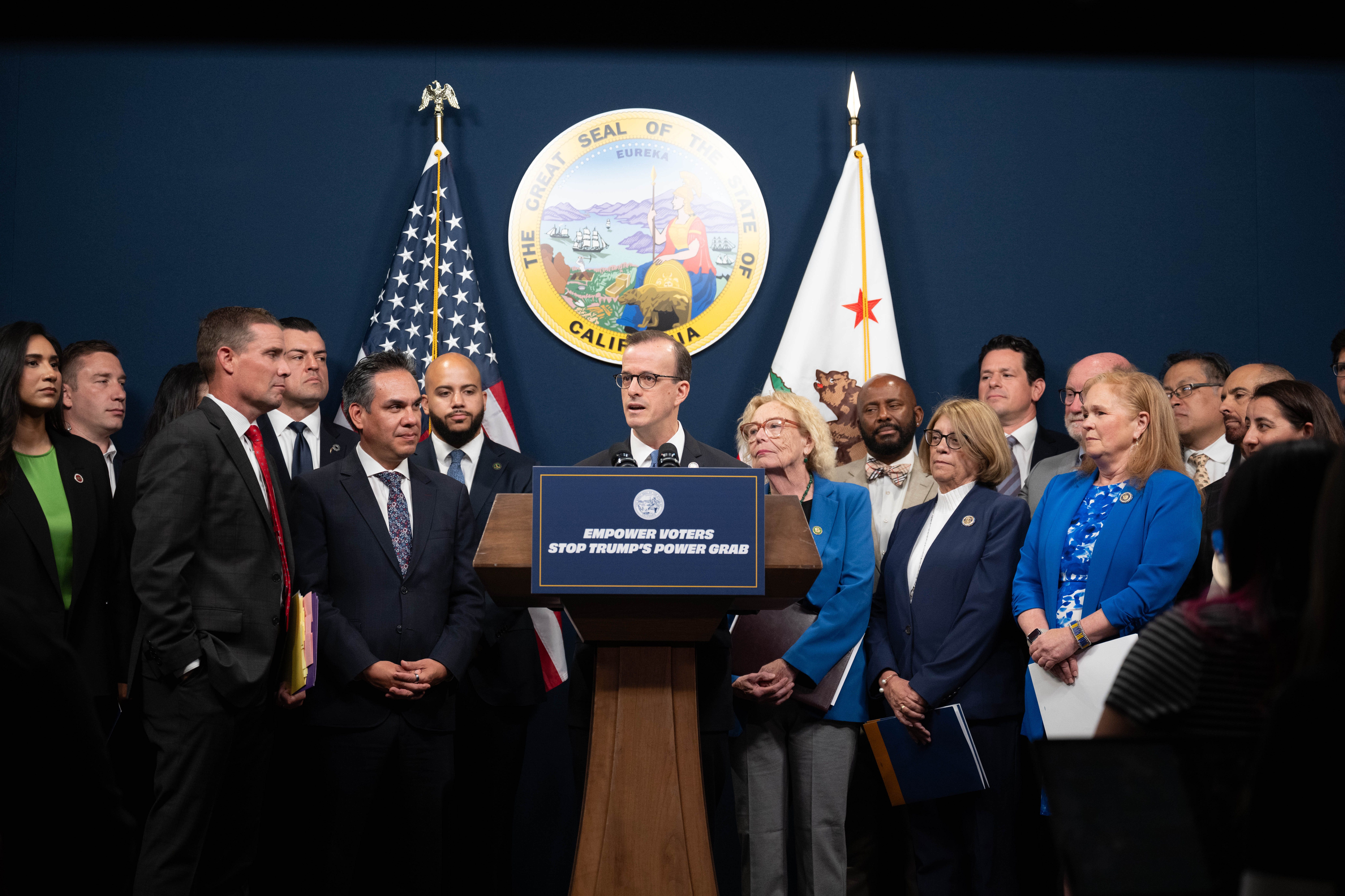 Assemblymember Berman and members of the Legislature standing together at a press conference introducing the Election Rigging Response Act