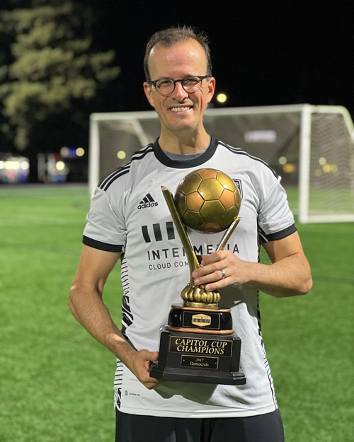 Asm. Berman holding soccer trophy