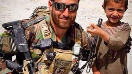 Captain Matthew Patrick Manoukian with a child