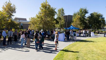 Outside photo of attendees from the presser