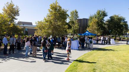 Outside photo of attendees from the presser