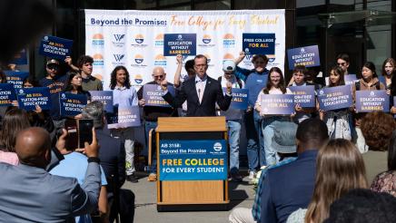 Asm. Berman speaking on the podium with attendees