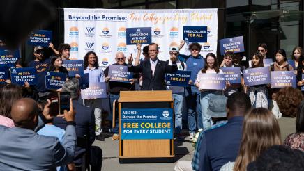 Asm. Berman speaking on the podium with attendees