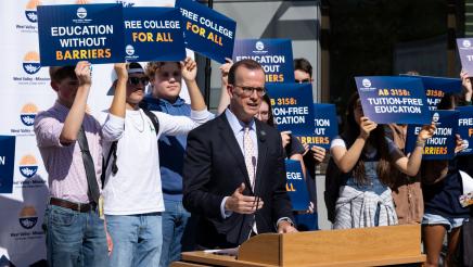 Asm. Berman speaking on the podium with attendees