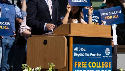 Asm. Berman speaking on the podium with attendees