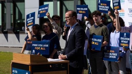 Asm. Berman speaking on the podium with attendees