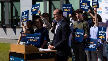 Asm. Berman speaking on the podium with attendees