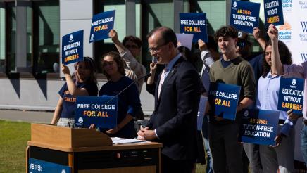 Asm. Berman speaking on the podium with attendees