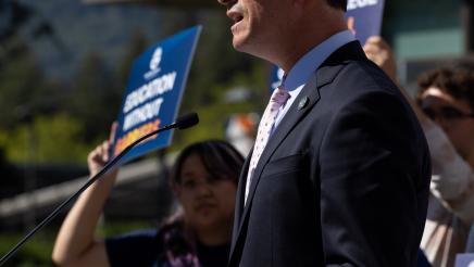 Asm. Berman speaking on the podium with attendees