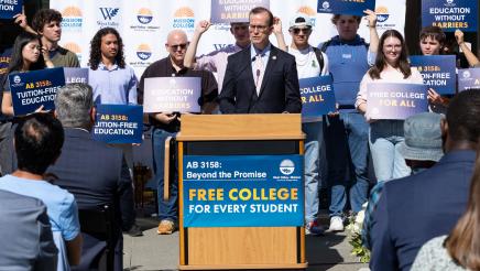 Asm. Berman speaking on the podium with attendees